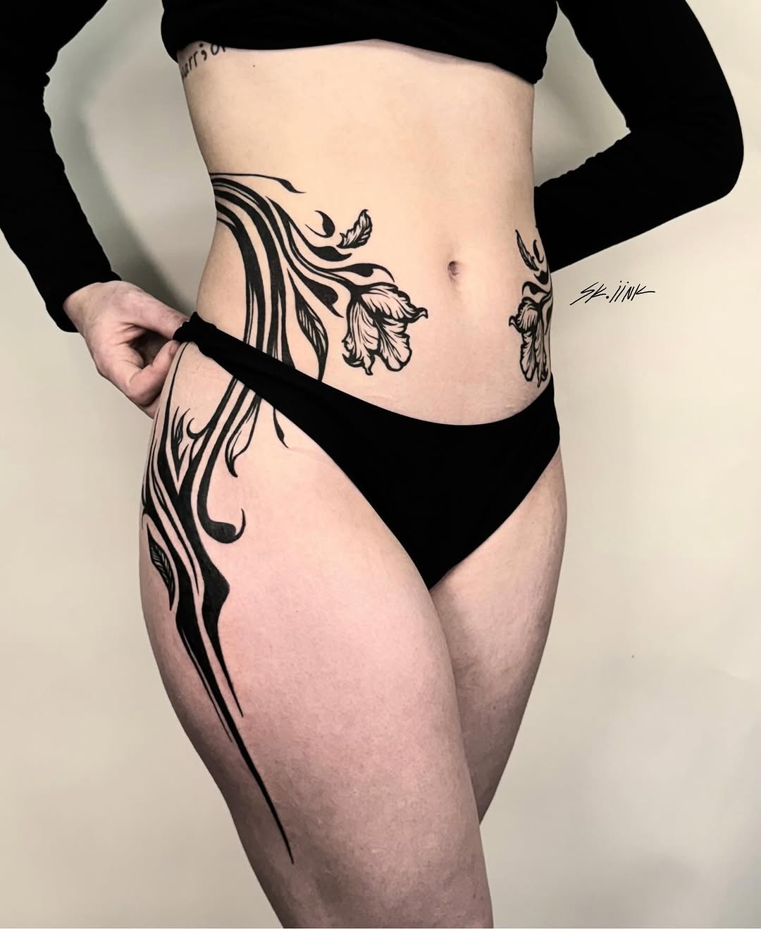 Tattoo by @sk.iink — illustrative, blackwork