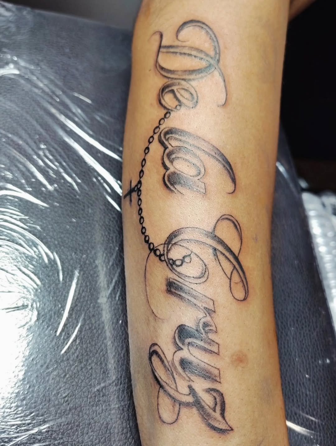 Tattoo by @inkw.ivy — lettering_script, black_and_grey