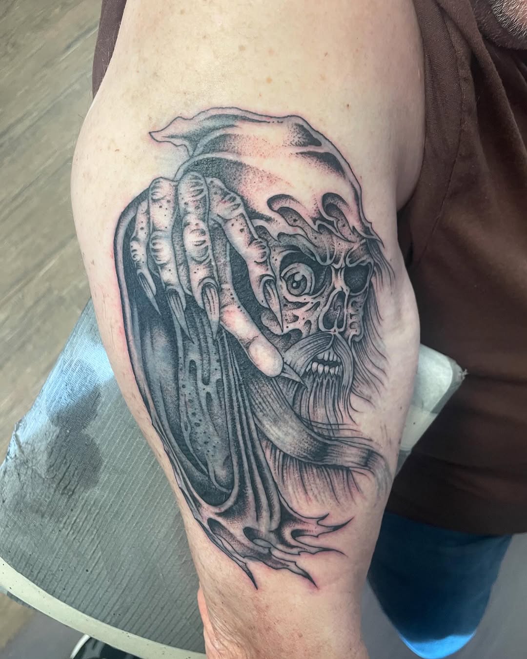 Tattoo by @brayden_p_tattoo — dark_realism, black_and_grey