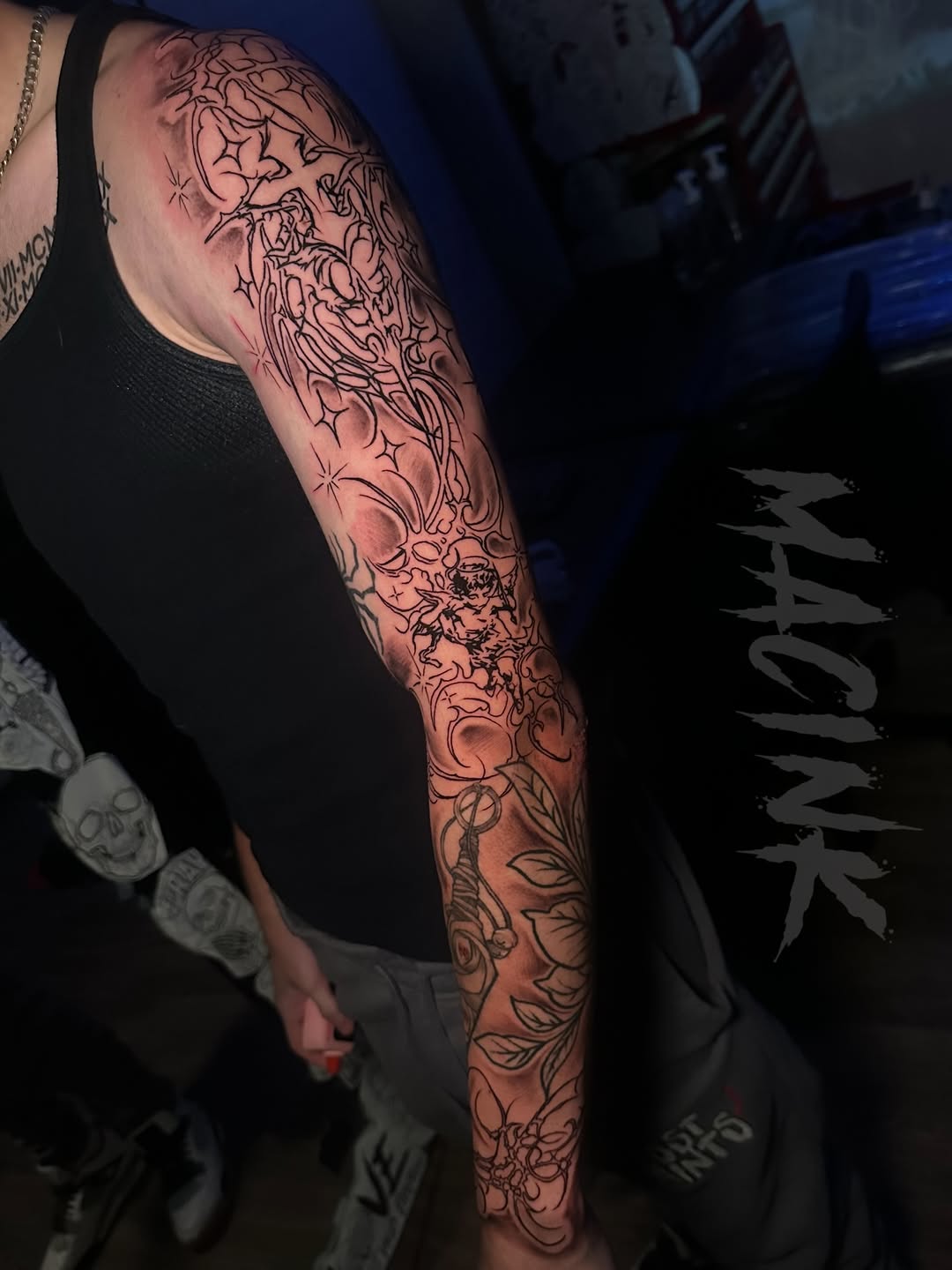 Tattoo by @macink__ — illustrative, blackwork