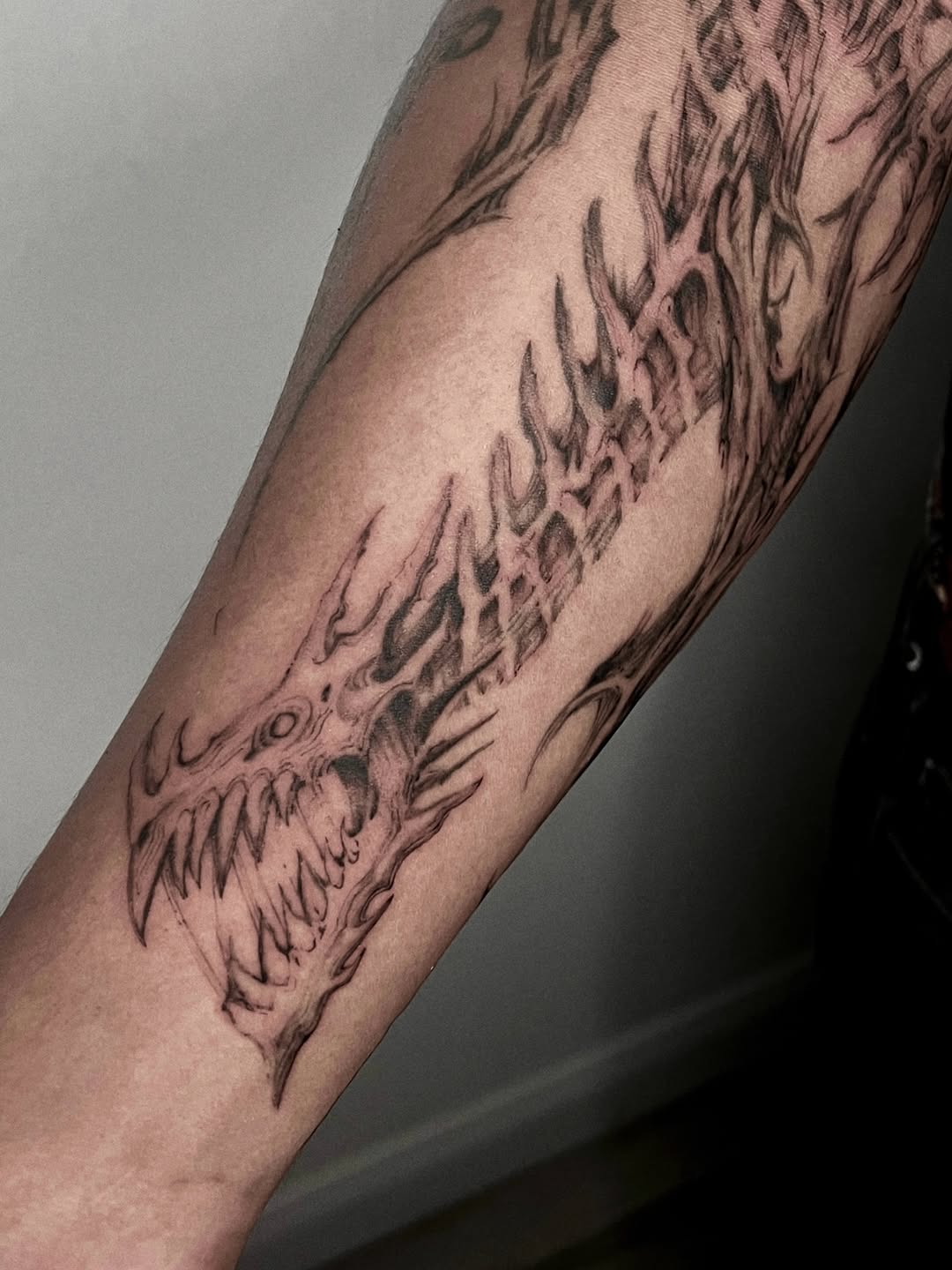 Tattoo by @rayzhu.tattoo — black_and_grey, dark_realism