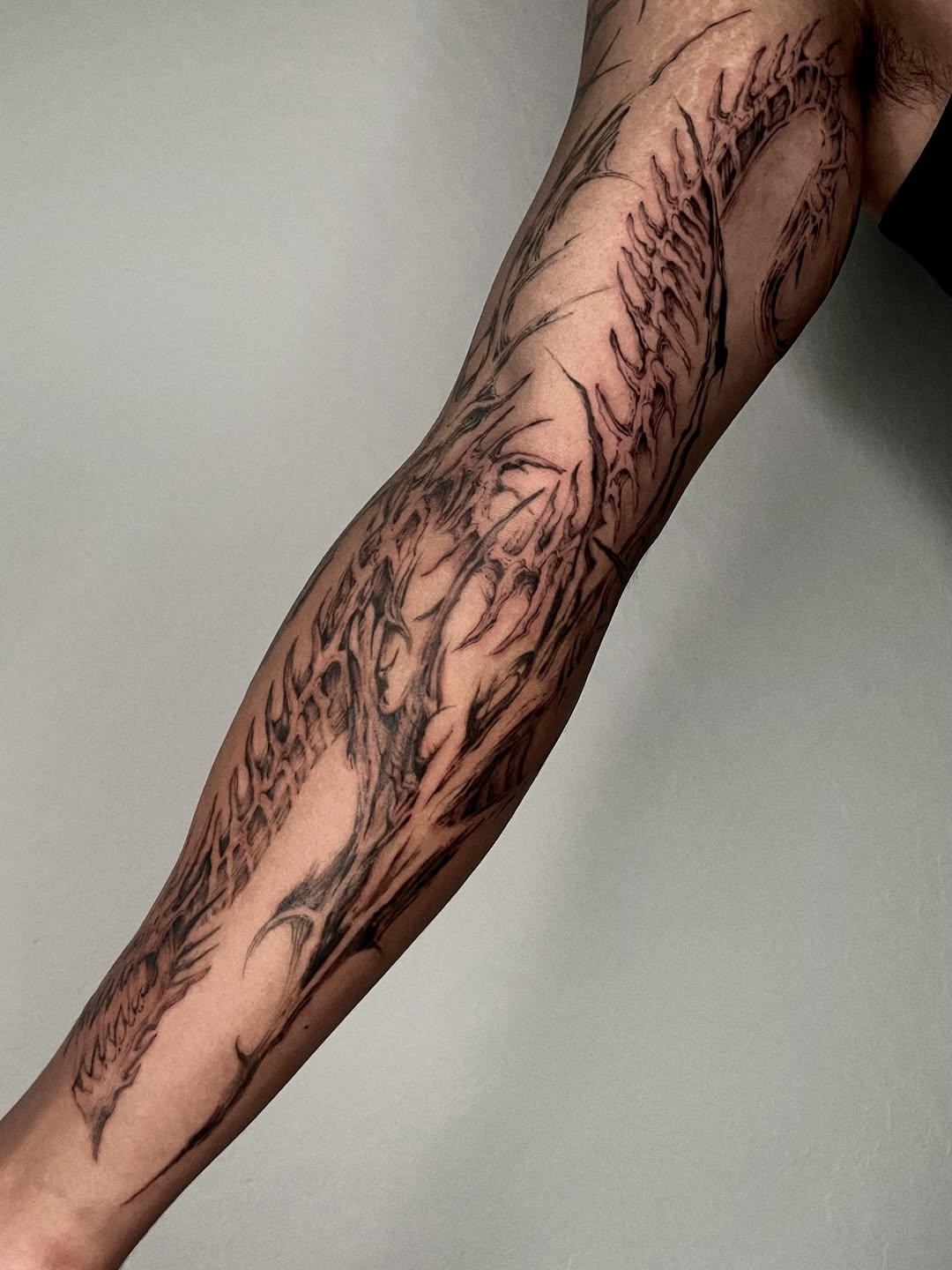 Tattoo by @rayzhu.tattoo — blackwork, dark_realism