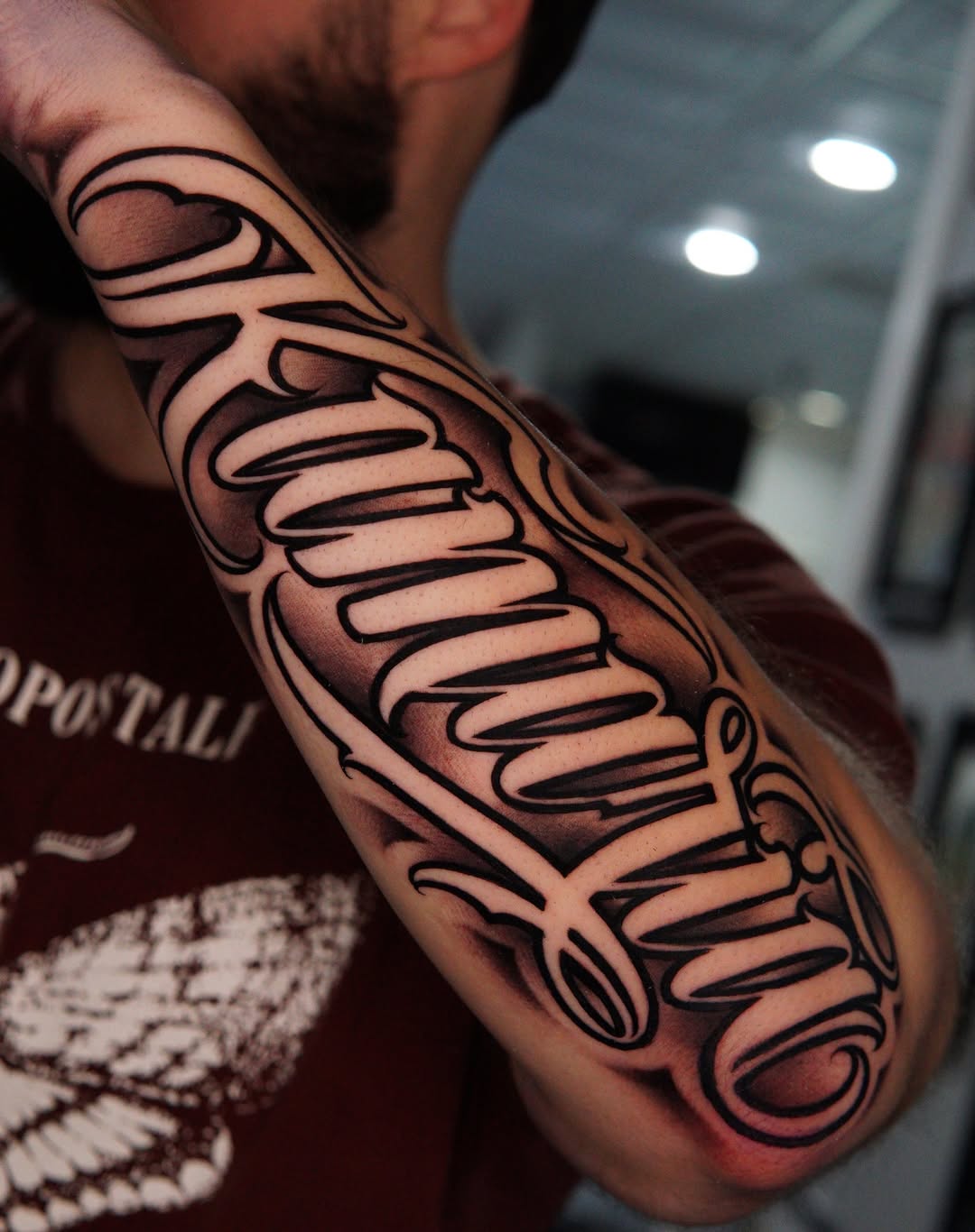 Tattoo by @tattoos.by.cristian — lettering_script, black_and_grey