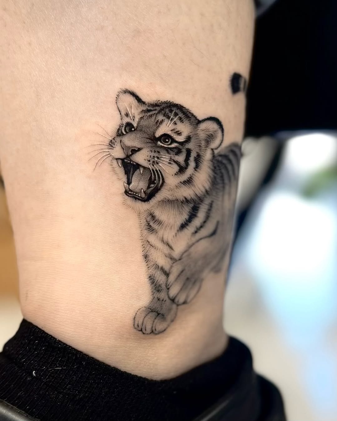 Tattoo by @tiny_tim.tatts โ realism, black_and_grey