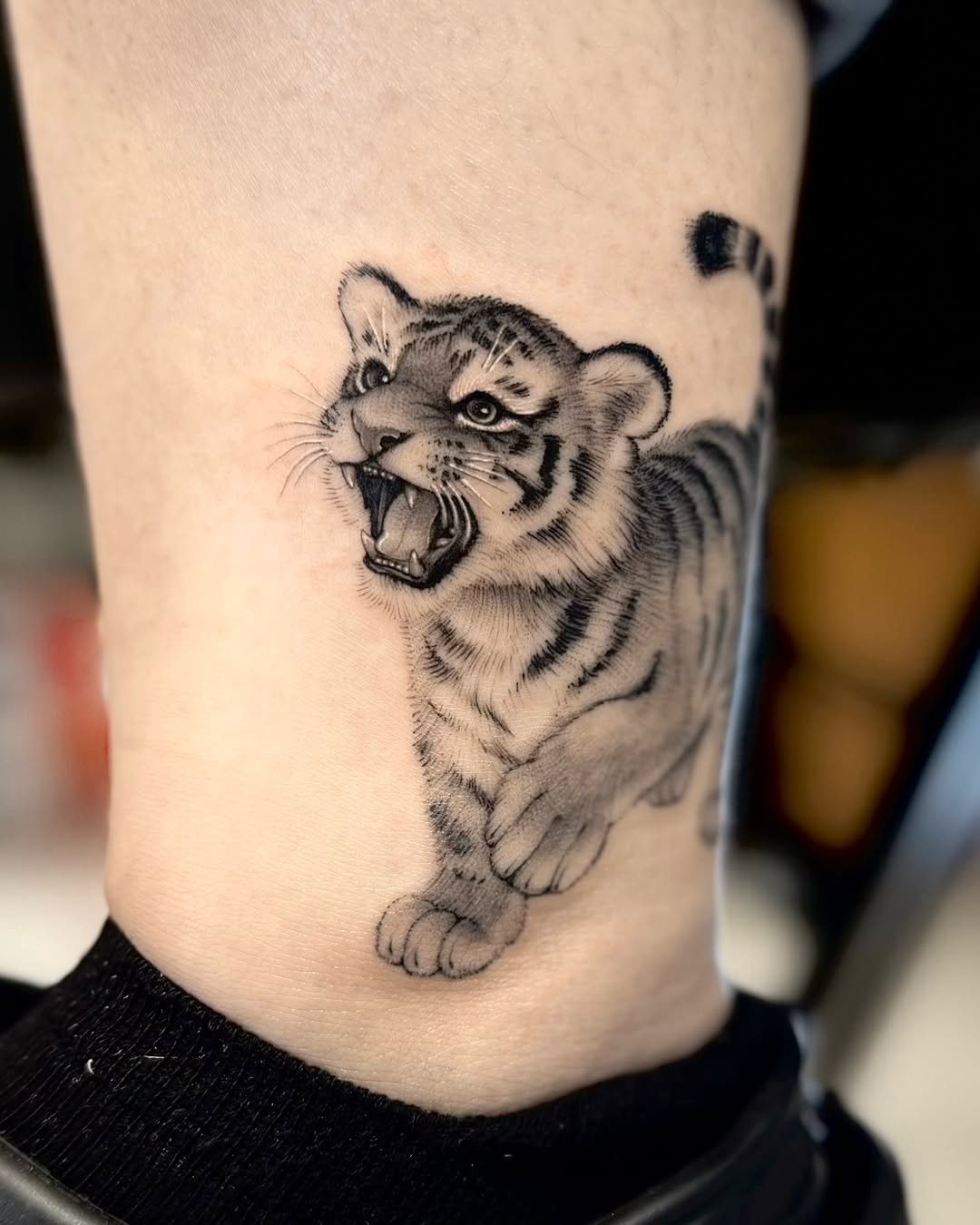 Tattoo by @tiny_tim.tatts โ realism, black_and_grey