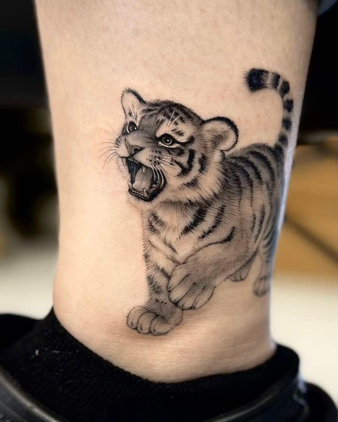 Tattoo by @tiny_tim.tatts โ realism, black_and_grey