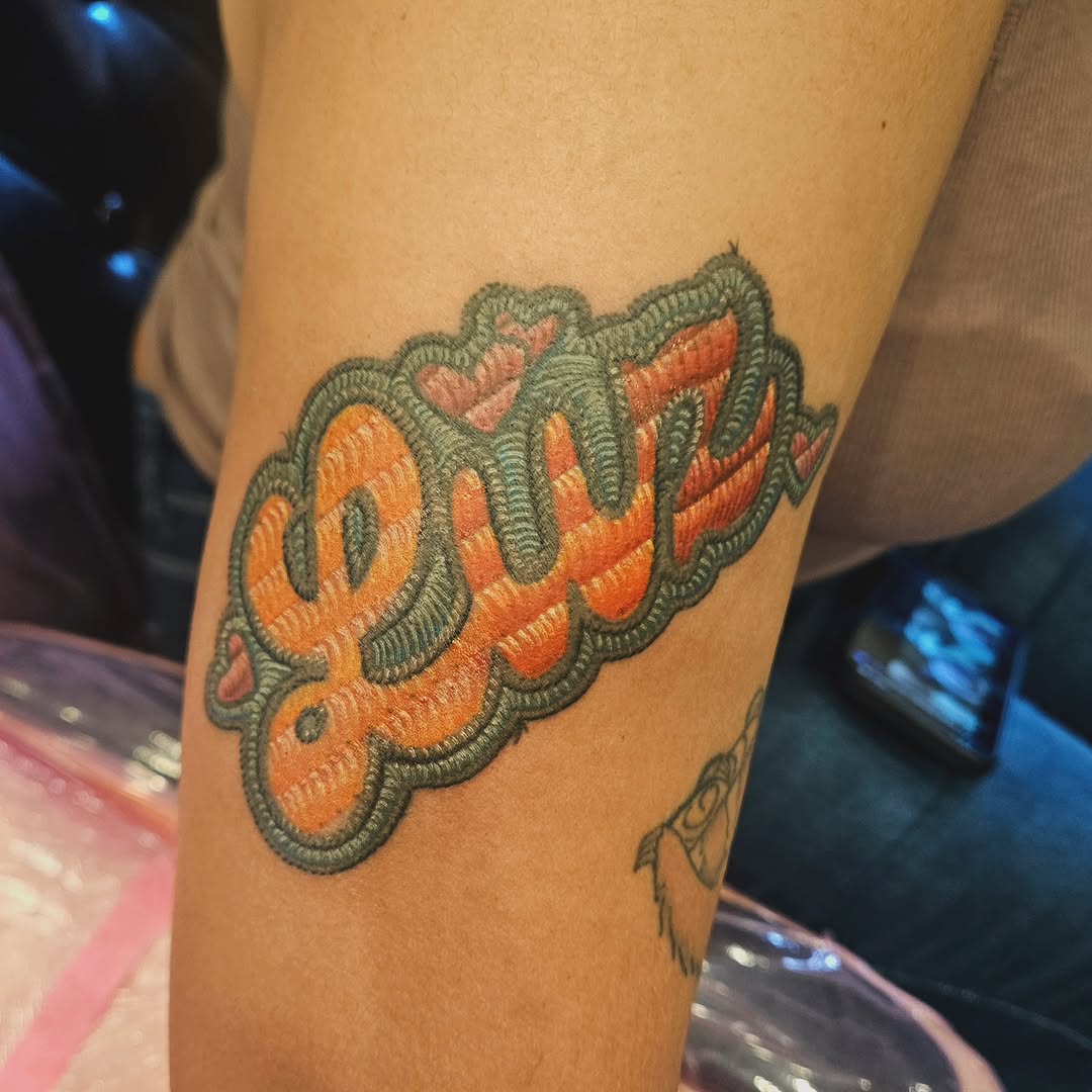 Tattoo by @hamilexis.art — lettering_script, illustrative