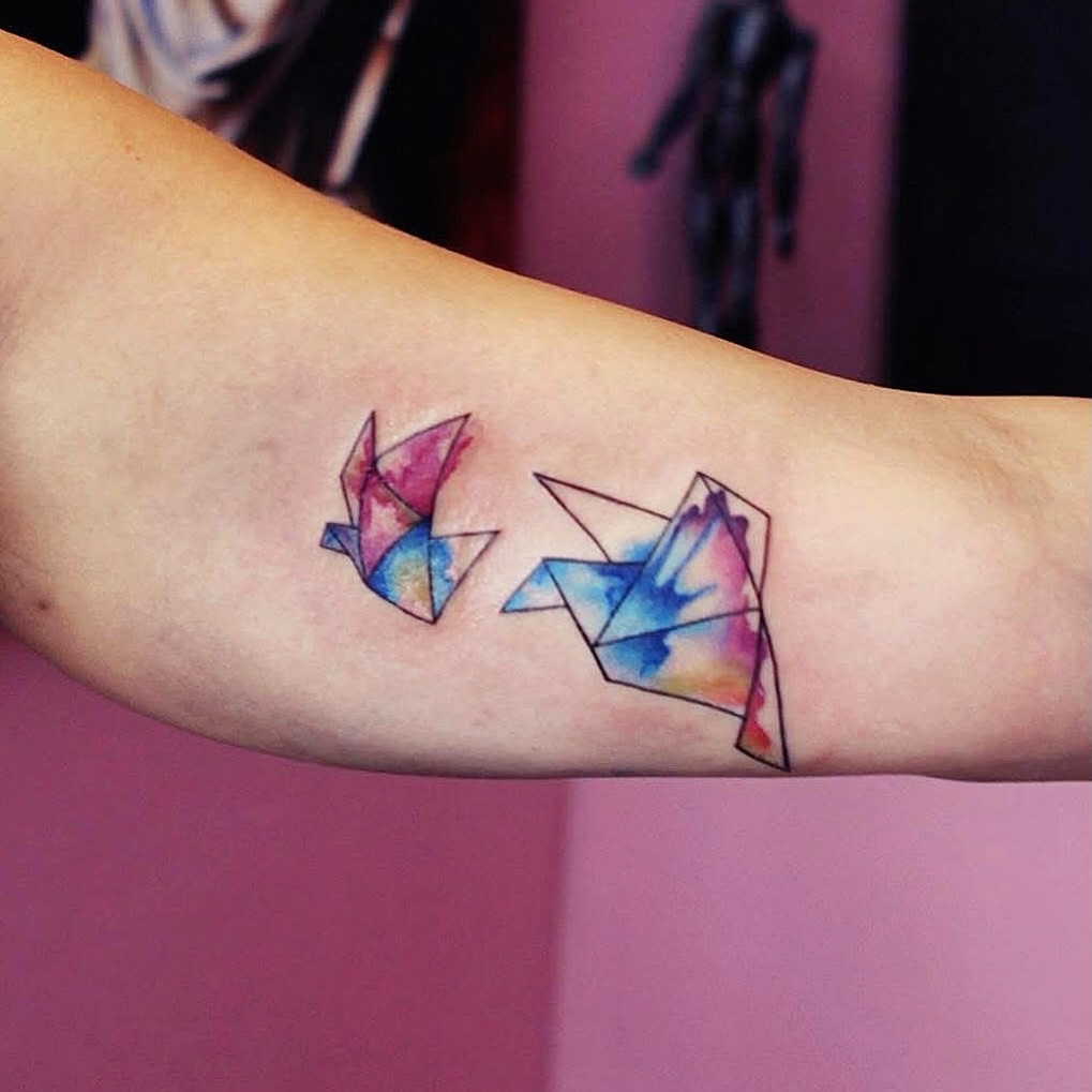 Tattoo by @stitchme.aizen_nyc — watercolor, geometric