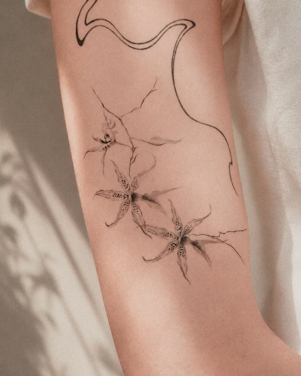 Tattoo by @ian.tattt — fine_line, black_and_grey