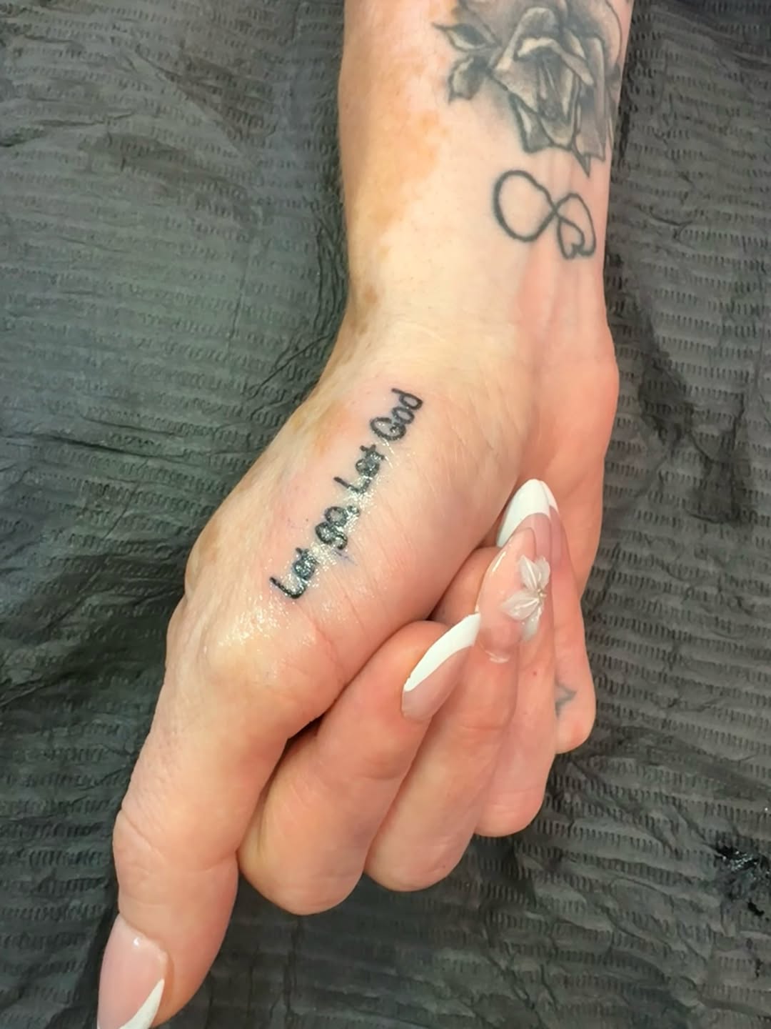 Tattoo by @riya.tatts.lv — lettering_script, fine_line