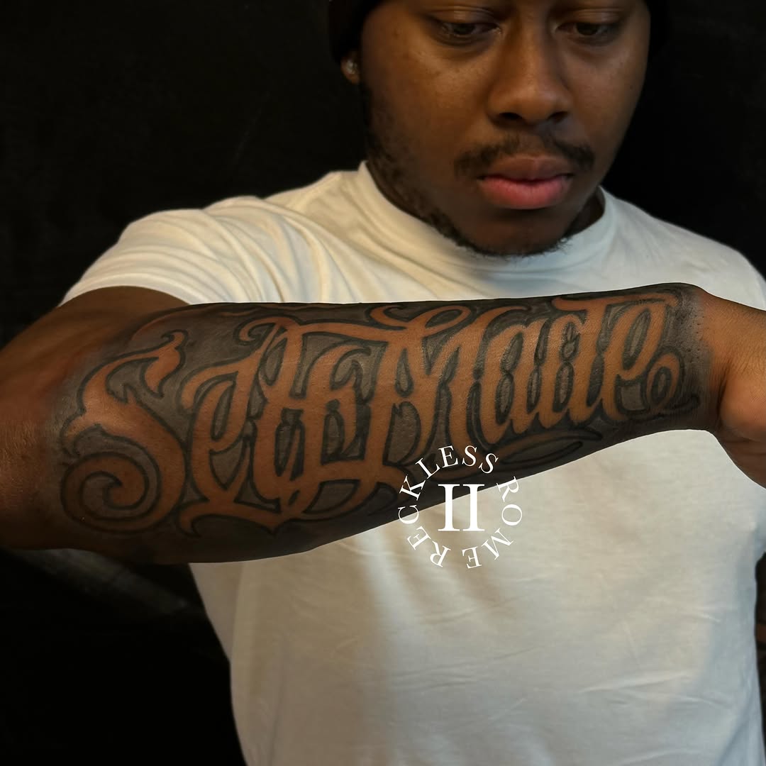 Tattoo by @2reckless__rome — lettering_script, chicano
