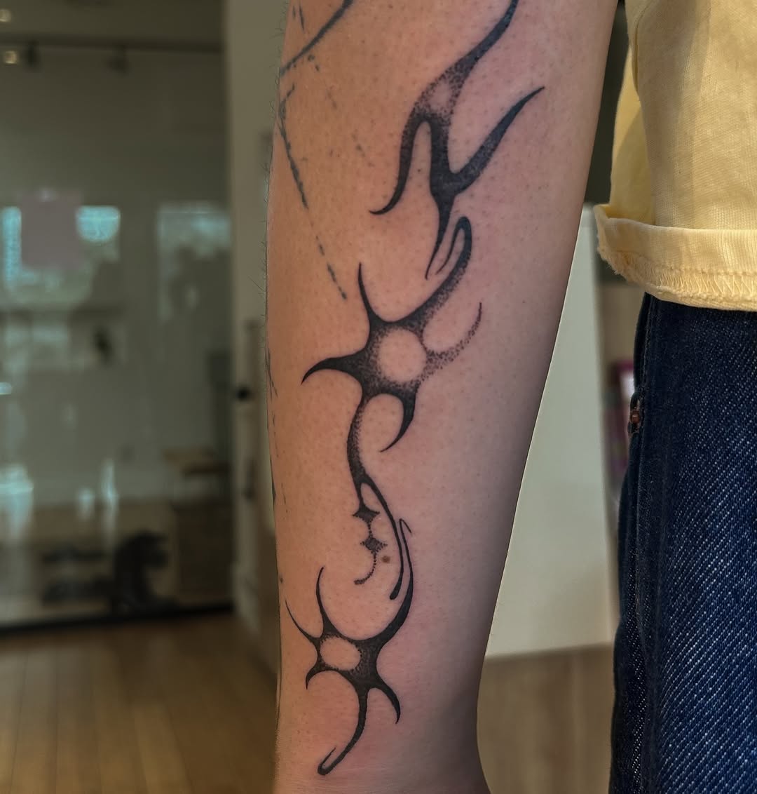 Tattoo by @oolong.ink — tribal, dotwork