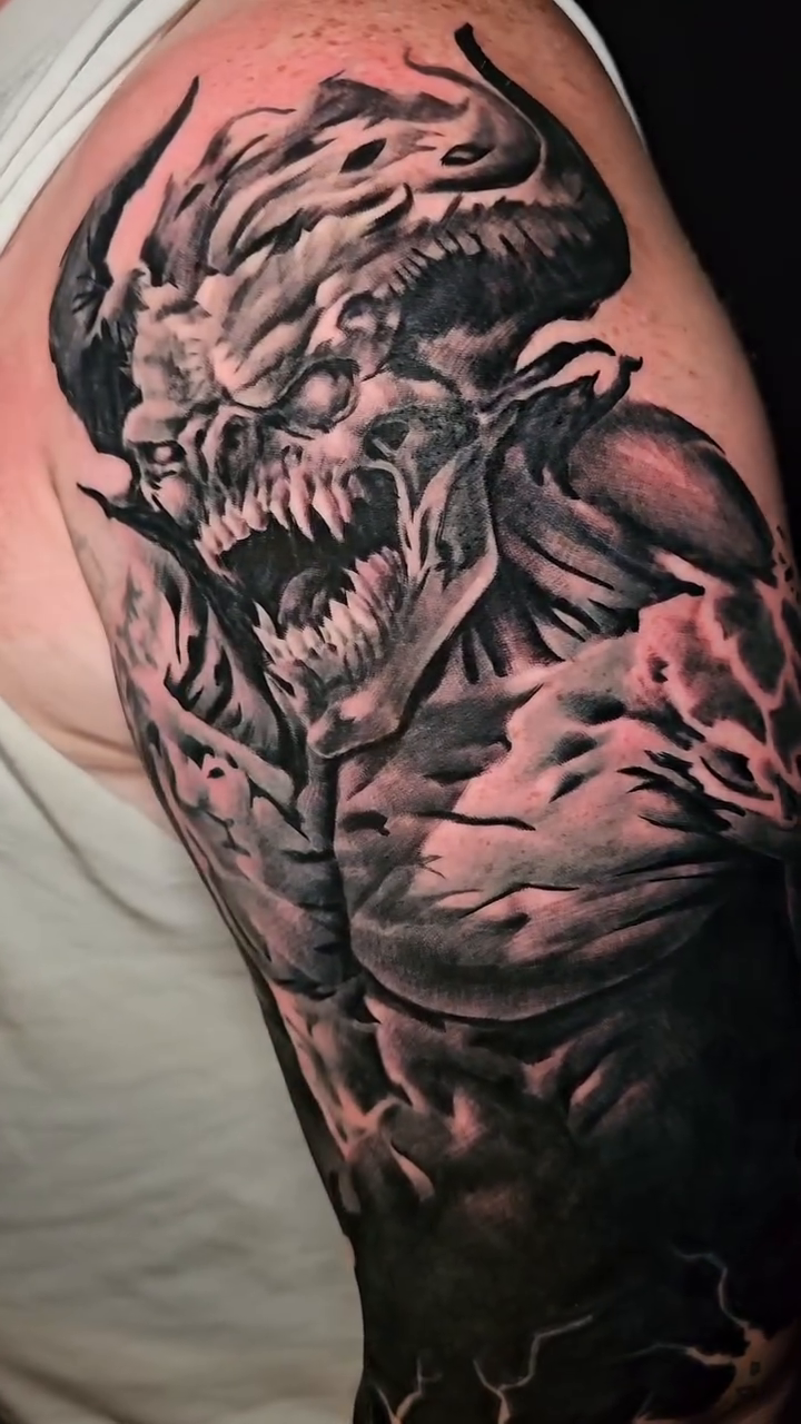 Tattoo by @johnniericotattoos — dark_realism, black_and_grey