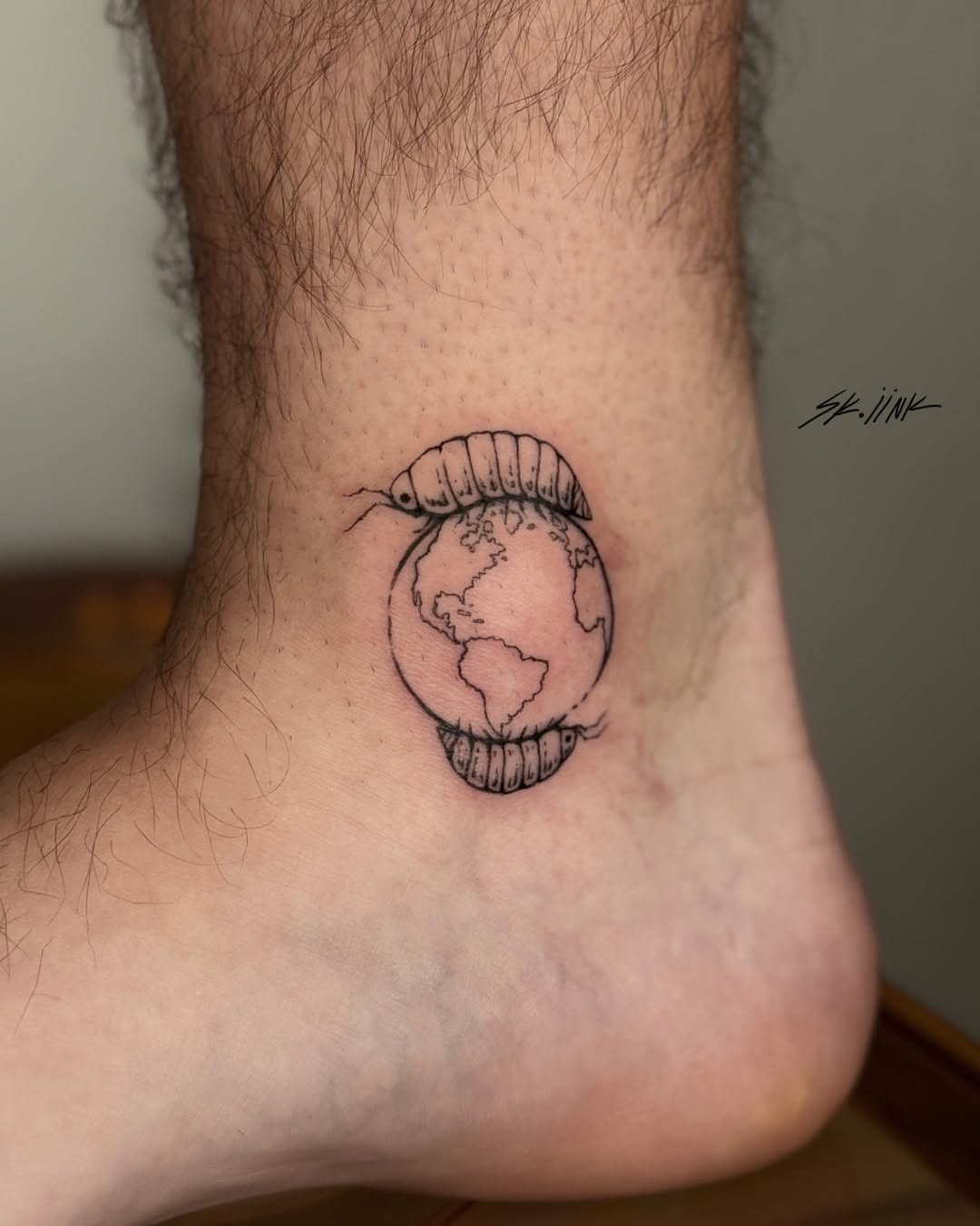Tattoo by @sk.iink — illustrative, blackwork