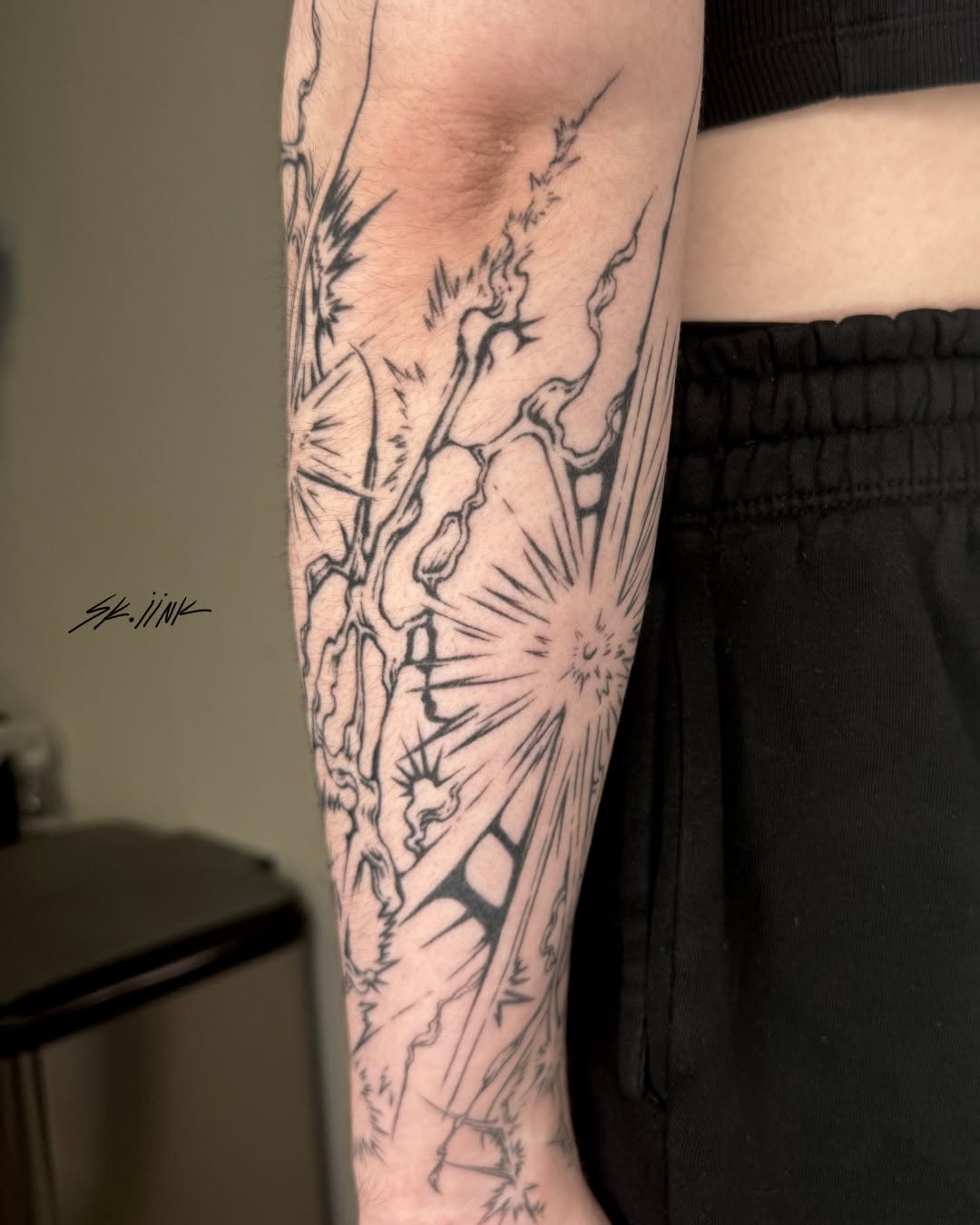 Tattoo by @sk.iink — illustrative, blackwork
