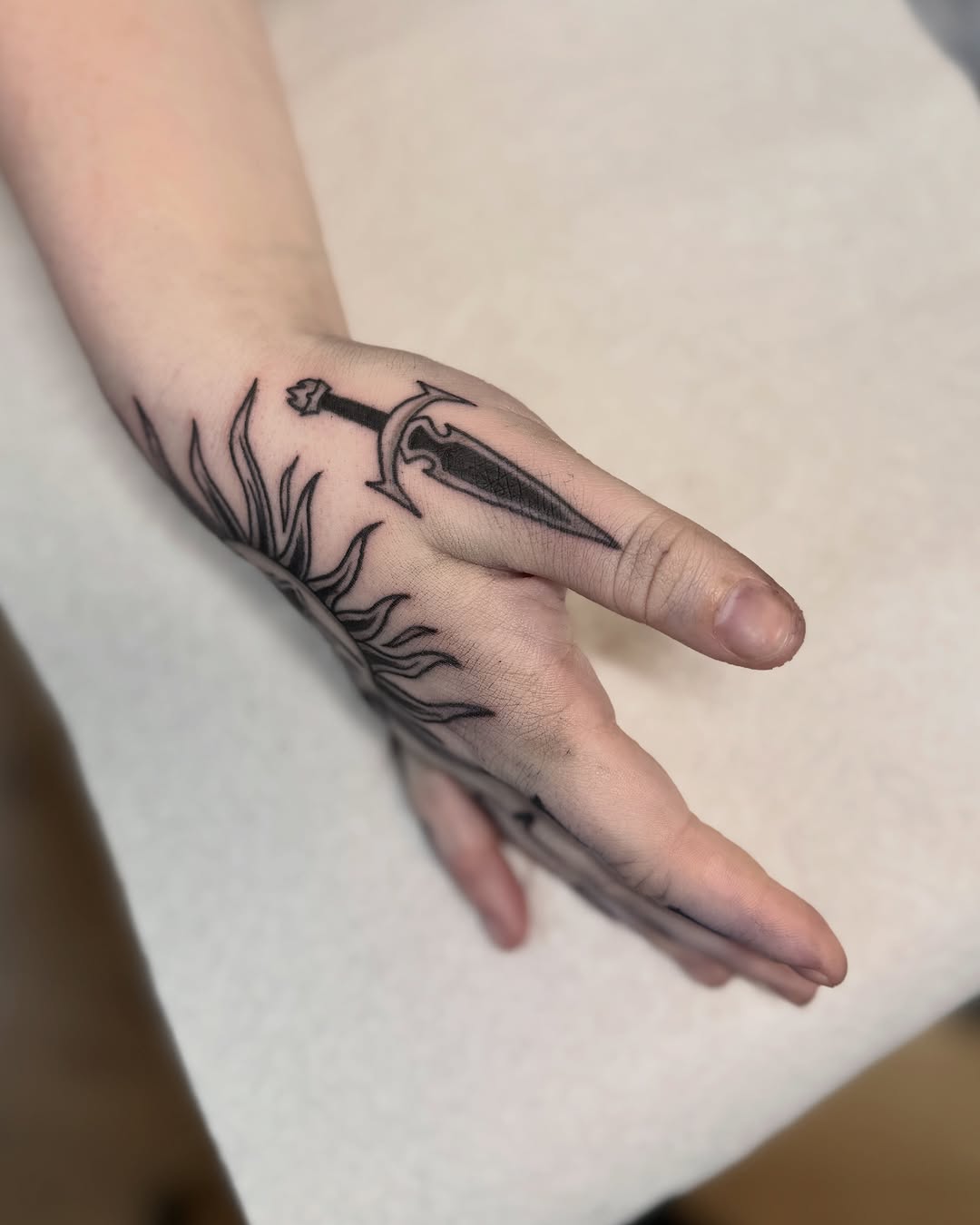 Tattoo by @niaink — illustrative, blackwork