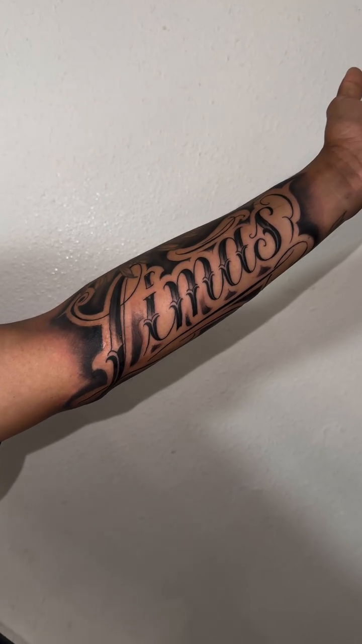 Tattoo by @miguelfernandez_tattoo — lettering_script, black_and_grey