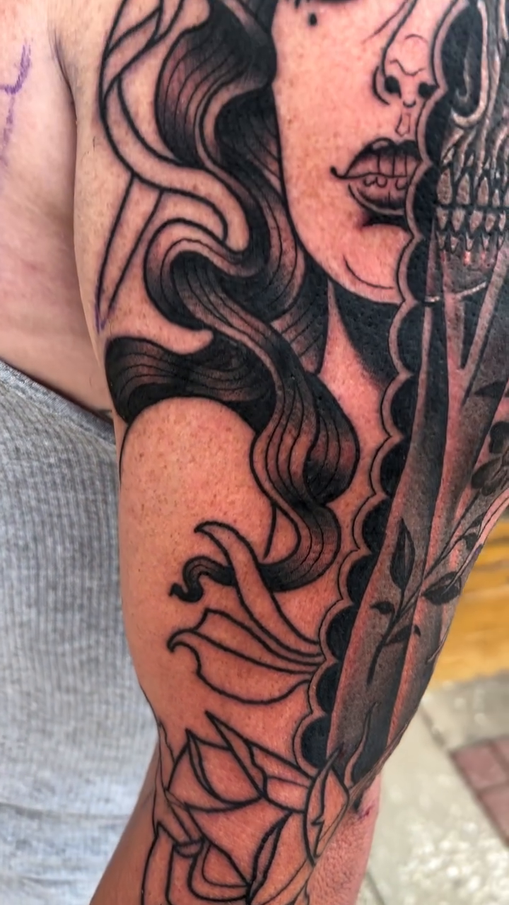 Tattoo by @bobby_ellis_tattooer — dark_realism, black_and_grey