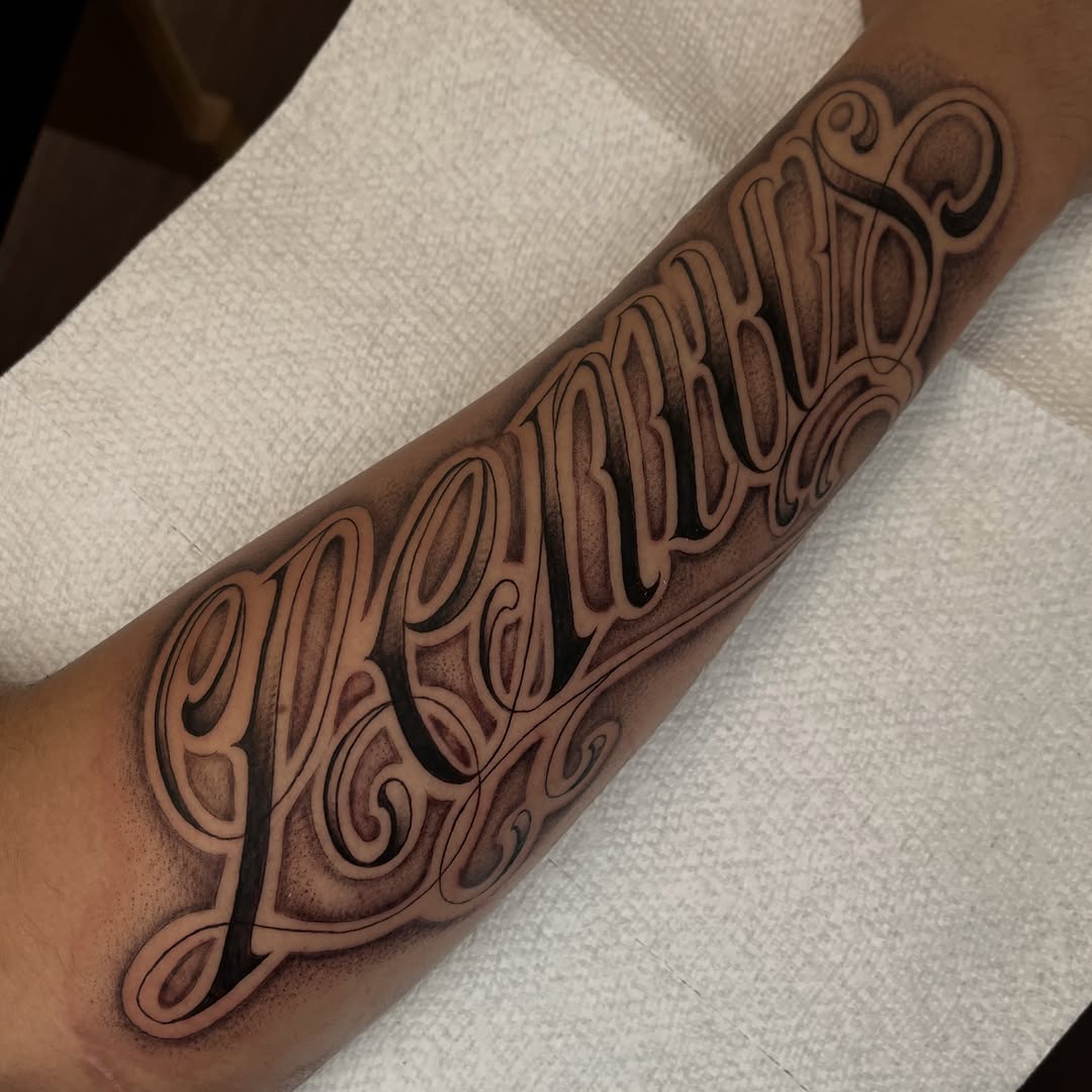 Tattoo by @jesus_pieces_ — lettering_script, chicano