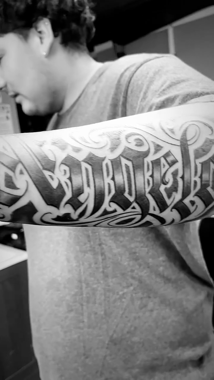 Tattoo by @jokertattoos — lettering_script, black_and_grey