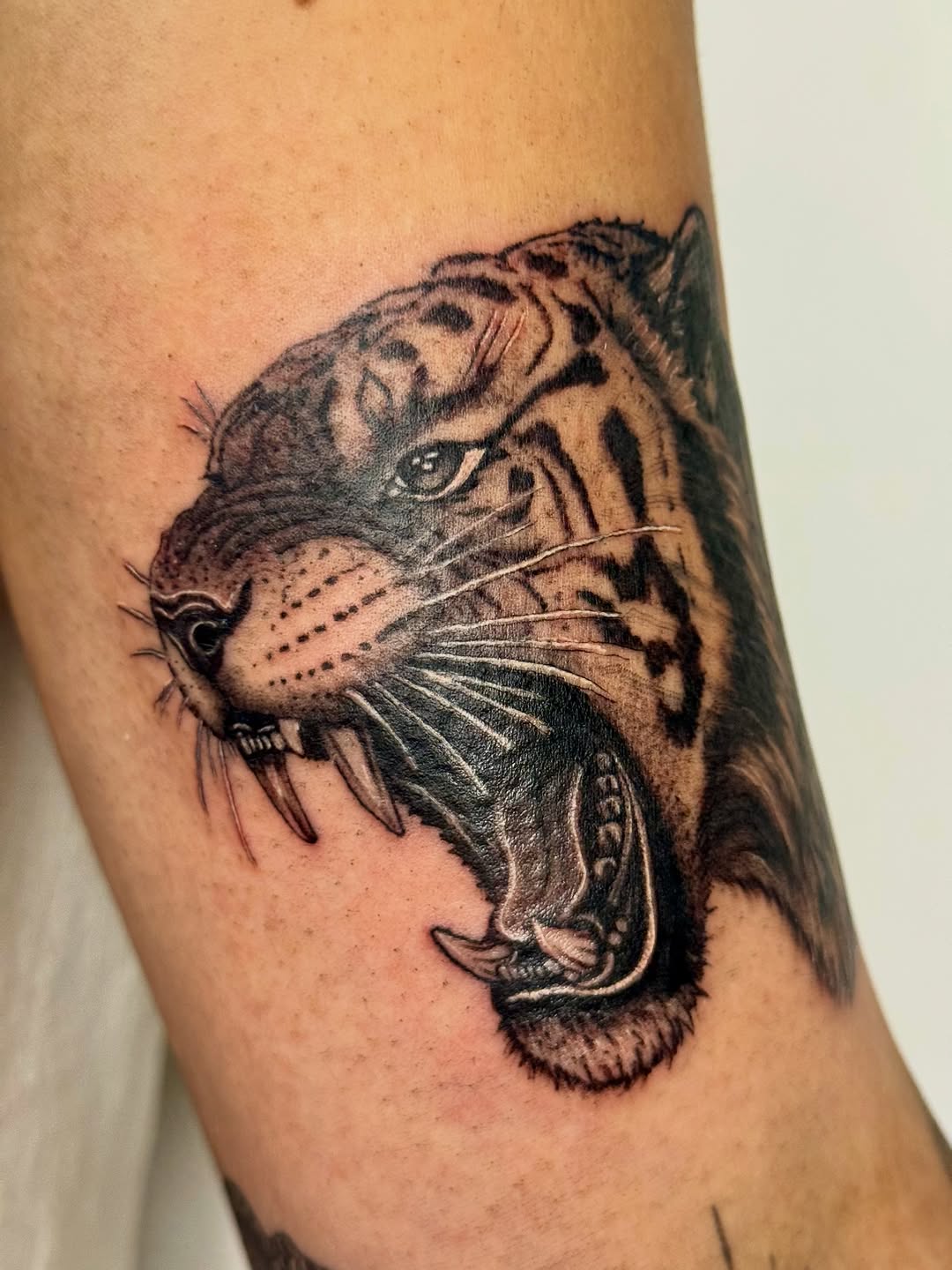 Tattoo by @21.12_ink โ realism, black_and_grey