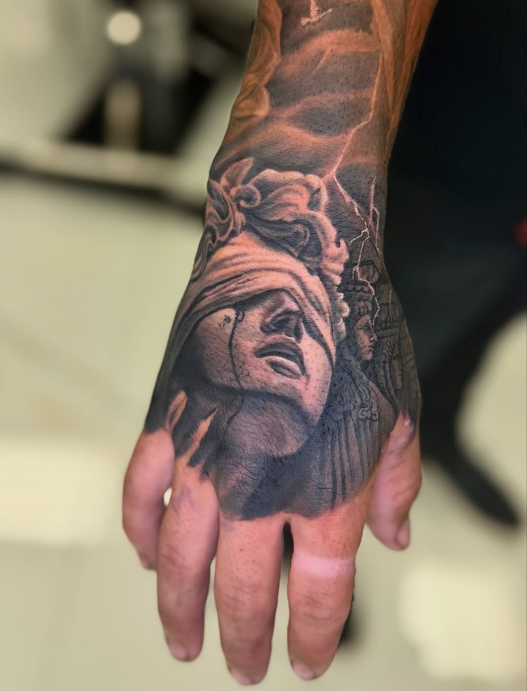 Tattoo by @tuannguyen_tattoo — realism, black_and_grey